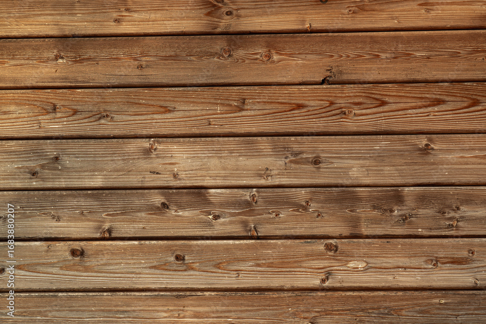 Fototapeta premium Neatly stacked light colored wooden planks in closeup. Smooth timber texture, natural grain pattern. Building material, interior design projects, background