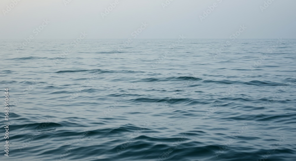 Obraz premium Calm Ocean Water with Mist and Foggy Horizon