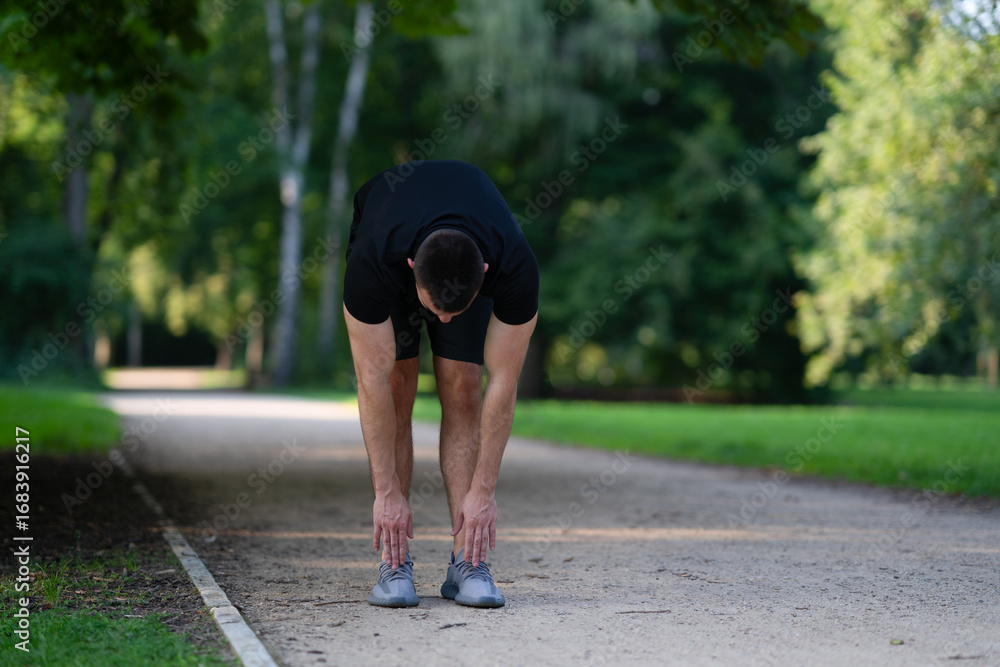 Fototapeta premium Man stretching in park