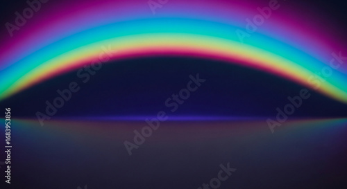 Vibrant rainbow arc reflecting on dark surface