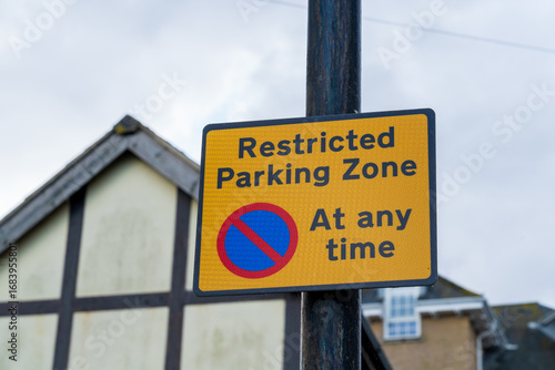 Uk road sign indicating a restricted parking zone and there is no parking at any time