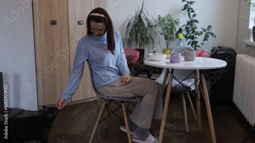 a young woman having breakfast at home at the table