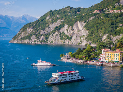 Como lake ferry boat, Lombardy, Italy. Aerial panoramic drone view of ship sailing between Menaggio, Varenna and Bellagio