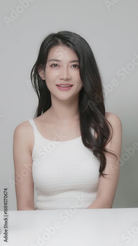 Portrait of a beautiful woman looking at the camera and smiling, beauty concept