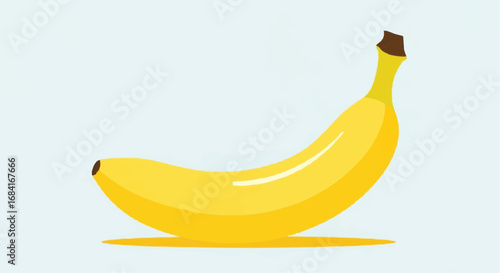 A bright yellow banana rests on a light blue background with a subtle shadow.