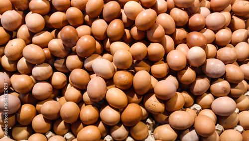 Piles of eggs displayed in a market stall.