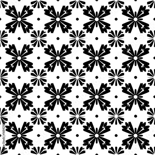 Black and white floral pattern with symmetrical flower shapes and circular dots arranged in a grid like design