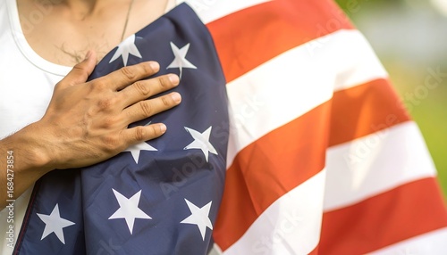 A person holding an American flag close to their chest