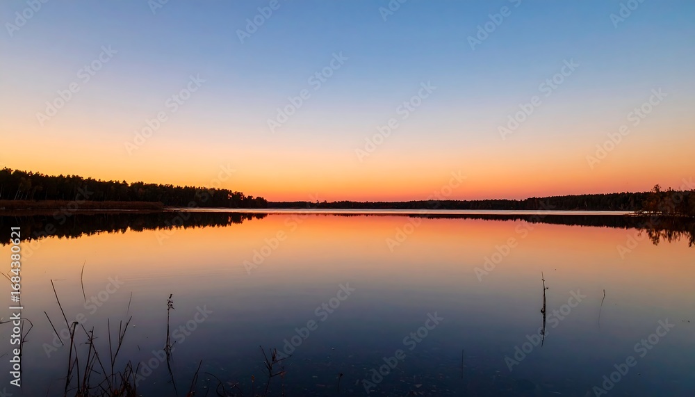 Naklejka premium Sunset Over a Calm Lake.