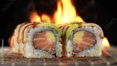 Burning Sushi Roll Preparation On Metal Grill Against Dark Background