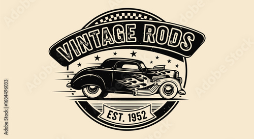 A vintage-style logo featuring a classic black hot rod with flames and an exposed engine, speeding within a circular emblem.