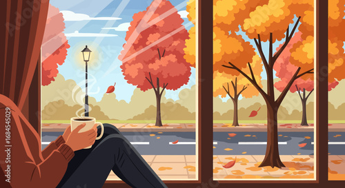 Relaxing autumn day a person sips a warm beverage, gazing out a window at a colorful street with fall foliage and gentle falling leaves