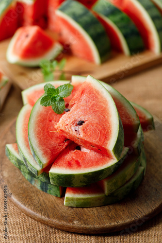 Slices of fresh watermelon on rustic wooden background.