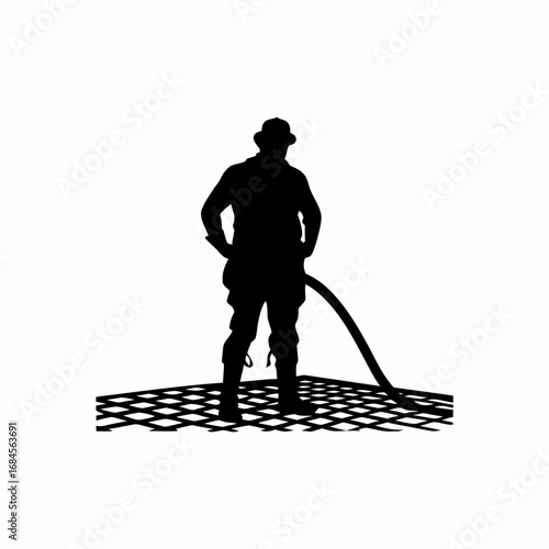Silhouette of construction worker pouring concrete on rebar grid