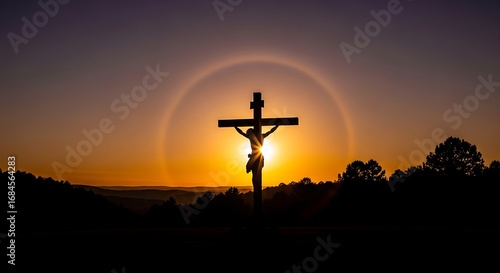 Silhouette of Jesus on the Cross with Glowing Sun Halo at Sunset in a Dramatic Spiritual Landscape
