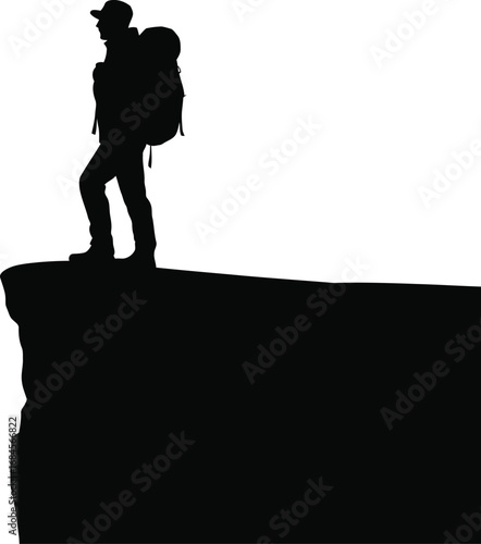 Adventurous hiker standing on a mountain cliff edge silhouette