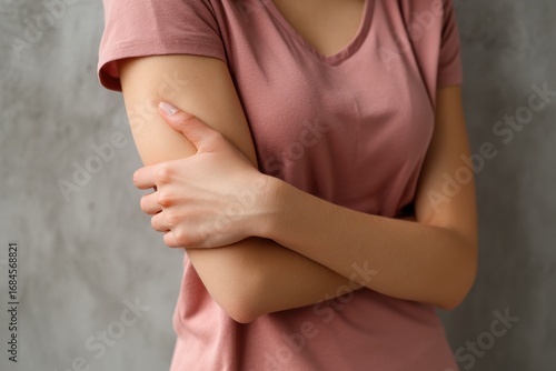 Wallpaper Mural Female gripping her arm in discomfort Torontodigital.ca