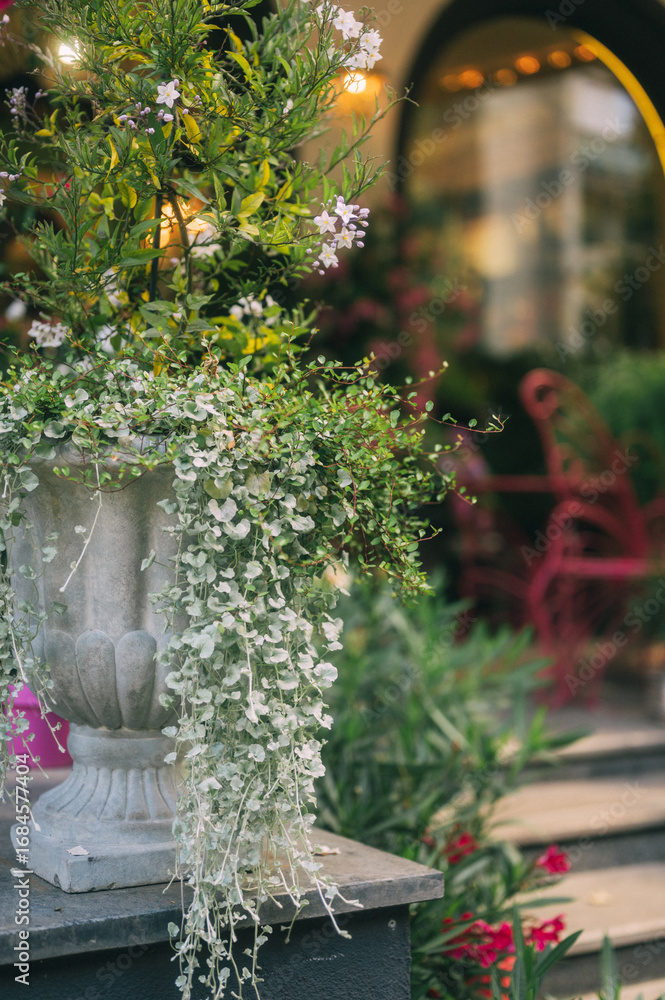 Fototapeta premium Elegant Floral Shopfront with Lush Greenery and Blooming Flowers