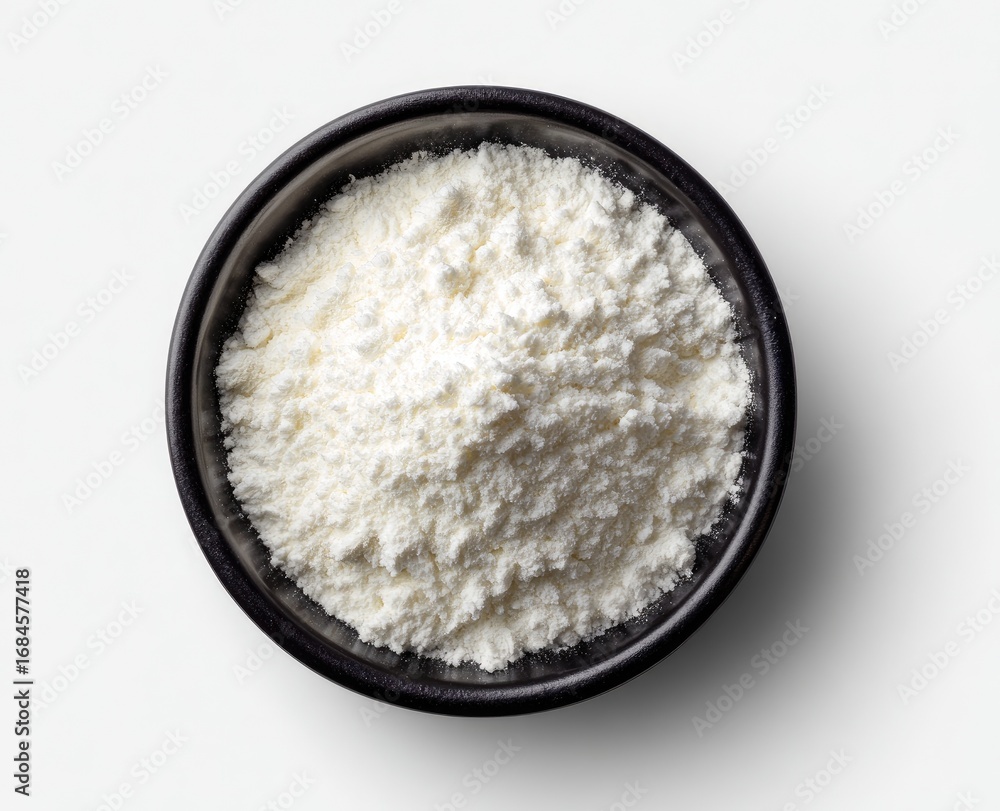 White flour in a dark bowl White flour in a dark bowl