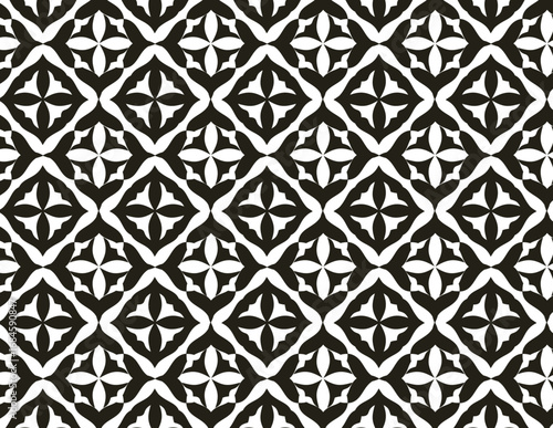 symmetrical, black and white geometric pattern with repeated quatrefoil and diamond shapes.