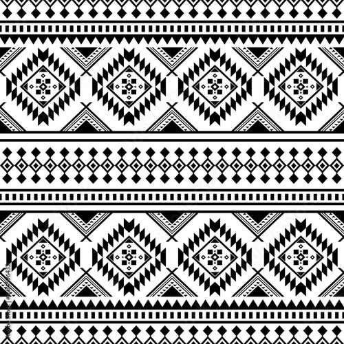 Black and White Geometric Tribal Pattern: A captivating, symmetrical pattern blending geometric shapes and tribal motifs to create an elegant and versatile background for design.