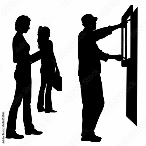 Silhouette of technician inserting program card into cnc machine panel