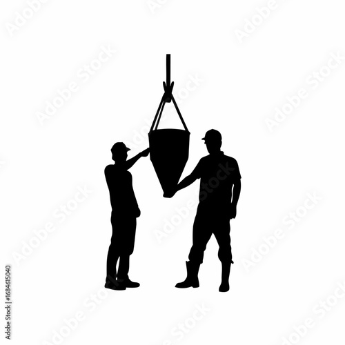 Silhouette of construction workers pouring concrete into formwork