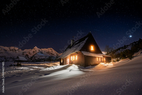 Snowy Mountain Cabin at Night