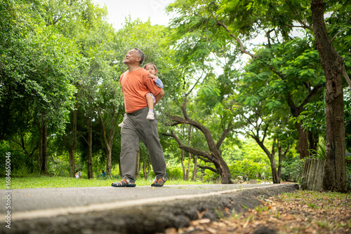 Grandfather and granddaughter jogging together in the park