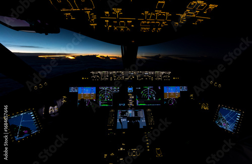 Sunset over the Pacific Ocean viewed from a Boeing 787 cockpit.