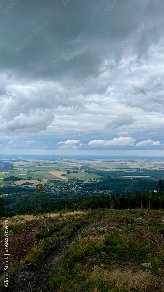 Obraz premium Opawskie Mountains, Poland. View from the summit to the mountain valley of the Czech Republic and Poland.