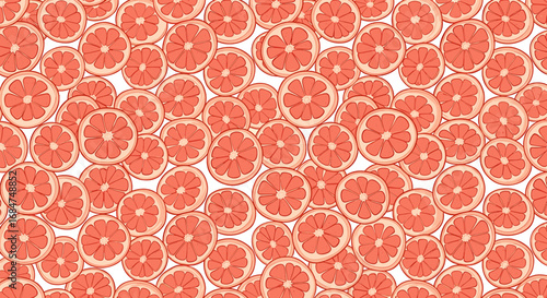 Close-up view of many grapefruit slices, creating a repeating pattern.