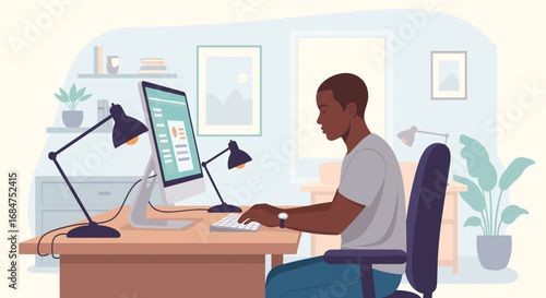 Young Black man focused on working at his modern home office desk with a computer. Represents remote work, productivity, business, and online learning concepts.