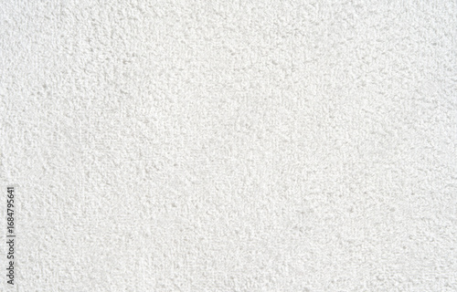 Close-up of textured white carpet surface with detailed fabric weave pattern.