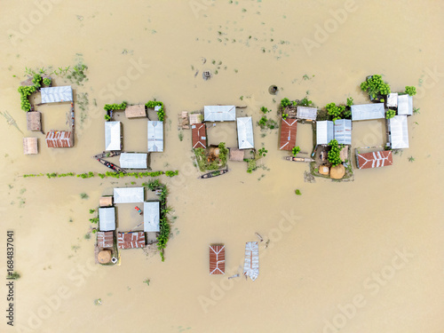 Aerial view of homes submerged in muddy floodwaters, rooftops barely visible amidst the deluge, Jatrapur Union of Kurigram District, Rangpur Division, Bangladesh.