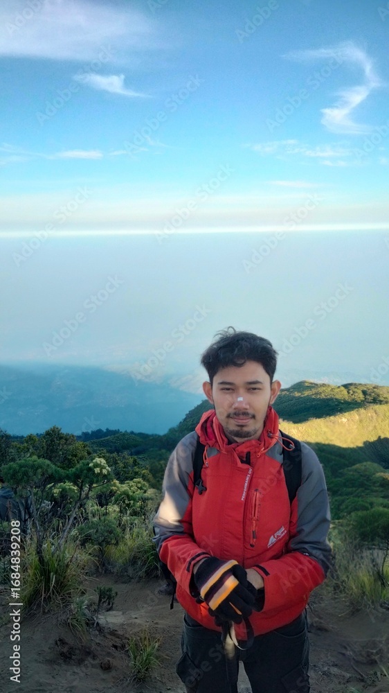 Naklejka premium hiker in the mountains, young man in the mountains