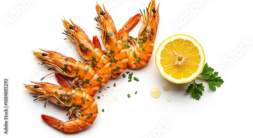 Close-up shot of grilled shrimp with herbs, a lemon half, and parsley on a white surface.