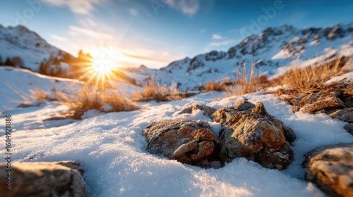 The natural beauty of snow-capped mountains illuminated by a warm sunrise creates a breathtaking landscape that evokes feelings of peace and adventure for any outdoor enthusiast.