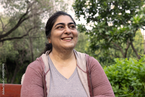 Indian beautiful mature woman smiling at the nature