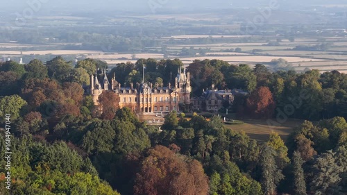 Aerial view of the historic Waddesdon Manor surrounded by lush forests in Buckinghamshire, England