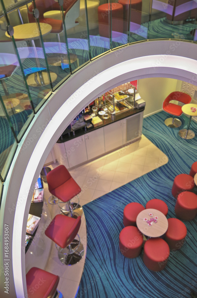 Fototapeta premium Single and mingle lounge bar snack bistro for solo travellers onboard modern cruiseship cruise ship liner in colorful futuristic interior design