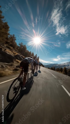 A group of cyclists racing along a scenic mountain road, surrounded by stunning landscapes, showcasing speed, teamwork, and the thrill of outdoor cycling in a picturesque natural setting.