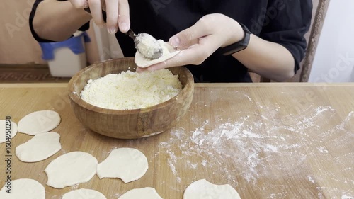 molding Ukrainian dumplings from dough and cheese