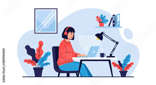 Young woman wearing headphones working on a laptop at a comfortable home office desk, surrounded by plants. Ideal for remote work, online education, or freelance business concepts.