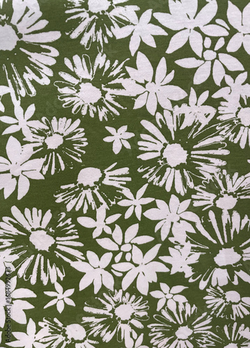 Green fabric with bold white floral print. Perfect for summer dresses, skirts, blouses, beachwear, and accessories. Fresh botanical textile design for fashion collections, crafts, and home decor.