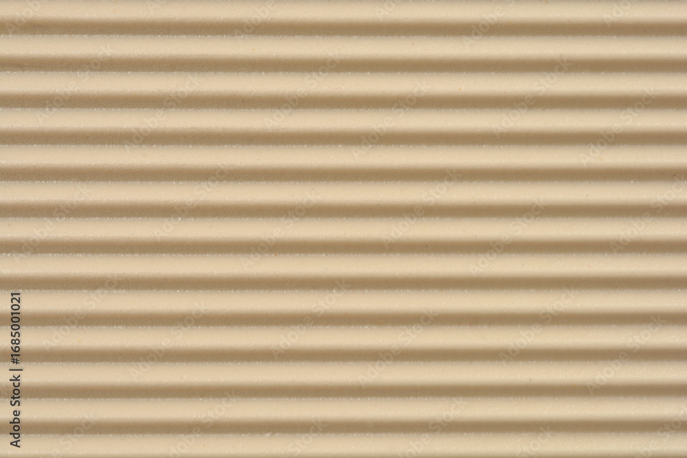 Obraz premium A full frame close-up shows a textured surface with horizontal parallel ridges and grooves in a beige tone