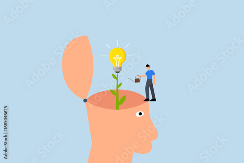 Grow new idea, businessman nurturing young plant with bright idea blossom