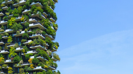 A stunning view of a green covered sustaineble building showcases innovative architecture blending nature and urban living under clear sky.