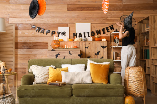Woman in witch hat hanging ...