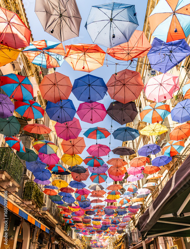 Fototapeta Naklejka Na Ścianę i Meble -  Umbrellas in a street near the Catania fish market on the island of Sicily.